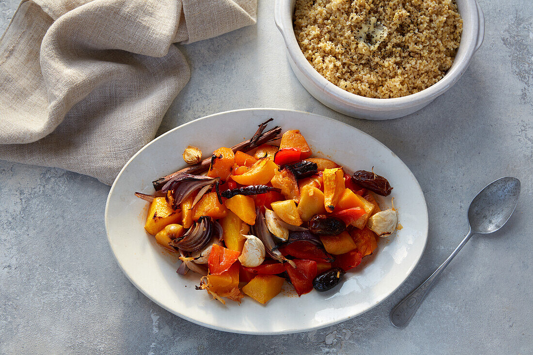 Spicy pumpkin and quince stew with dates and cracked wheat