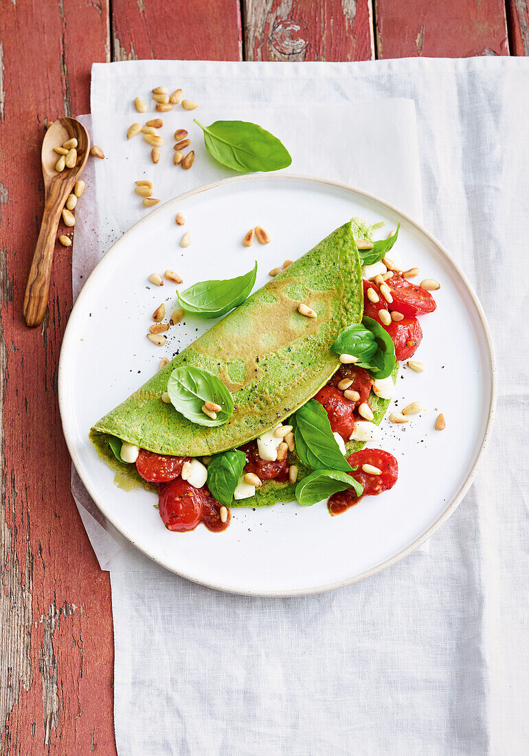 Spinach pancakes with tomatoes and mozzarella