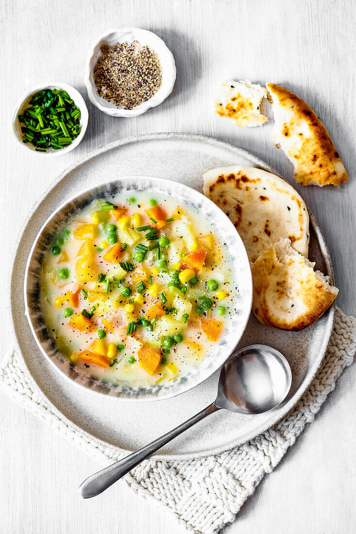 Creamy vegetable soup with sweetcorn, peas and carrots