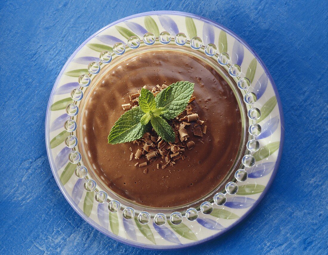 Chocolate blancmange in glass dish, with mint garnish