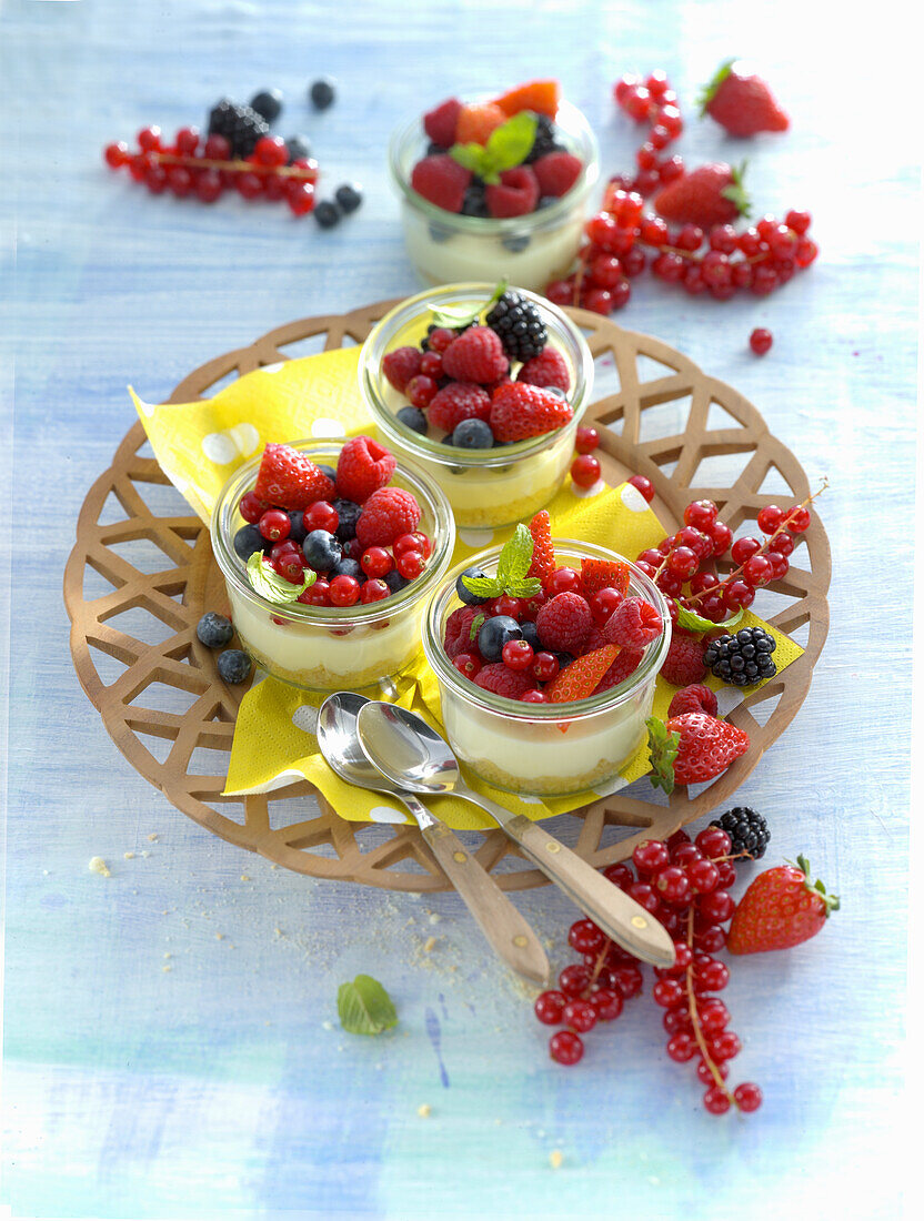 Vanilla cream tartlets with mixed berries in a jar