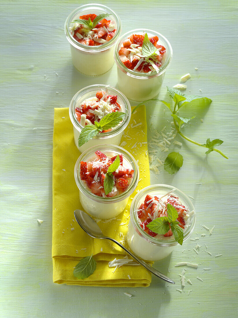 White chocolate mousse with strawberries, mint and chocolate shavings