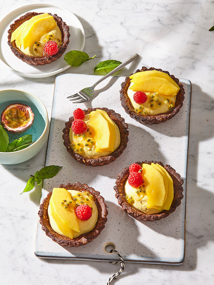 Exotic mango tartlets with passion fruit and raspberries