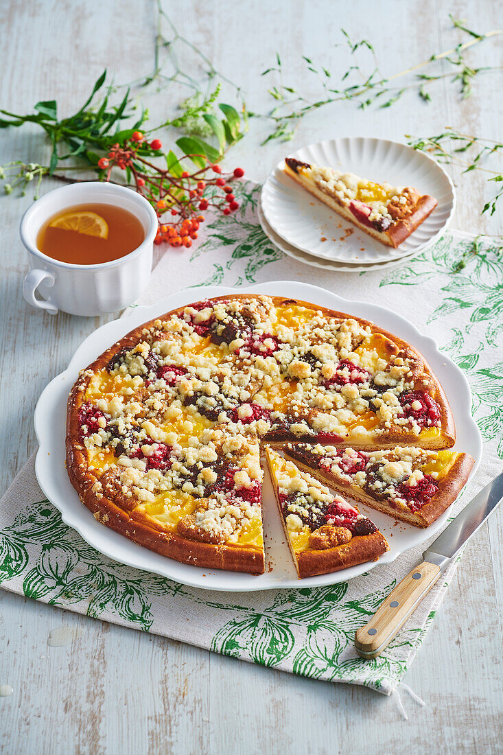 Yeast cake with cream cheese, raspberries, apricots and crumble