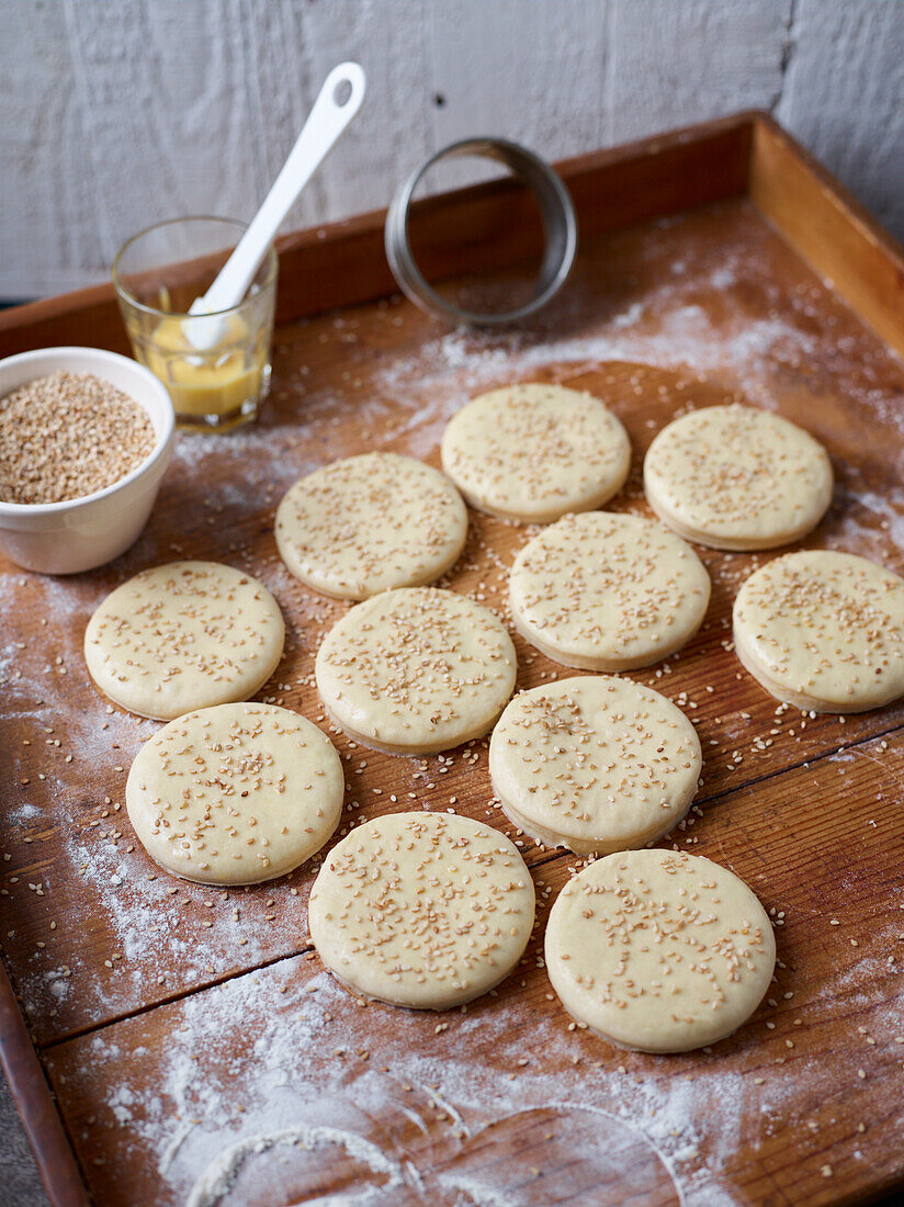 Unbaked hamburger buns with sesame seeds