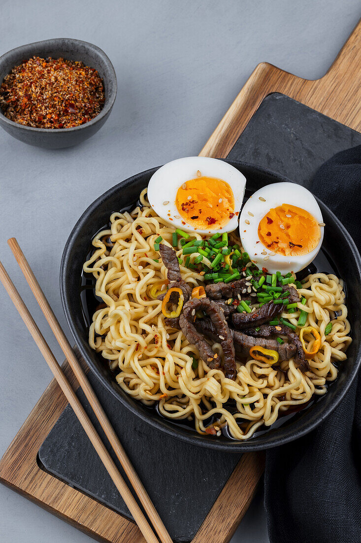 Asian noodle soup with egg and beef