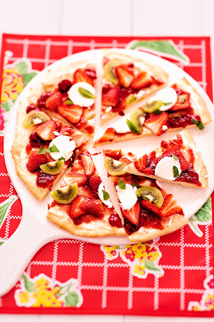 Sweet pizza with strawberry jam, strawberries and kiwi