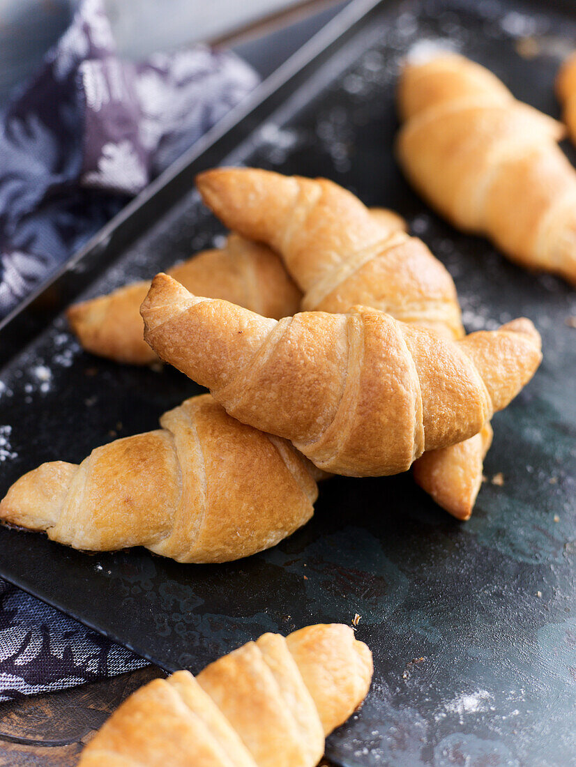 Croissants on baking tray