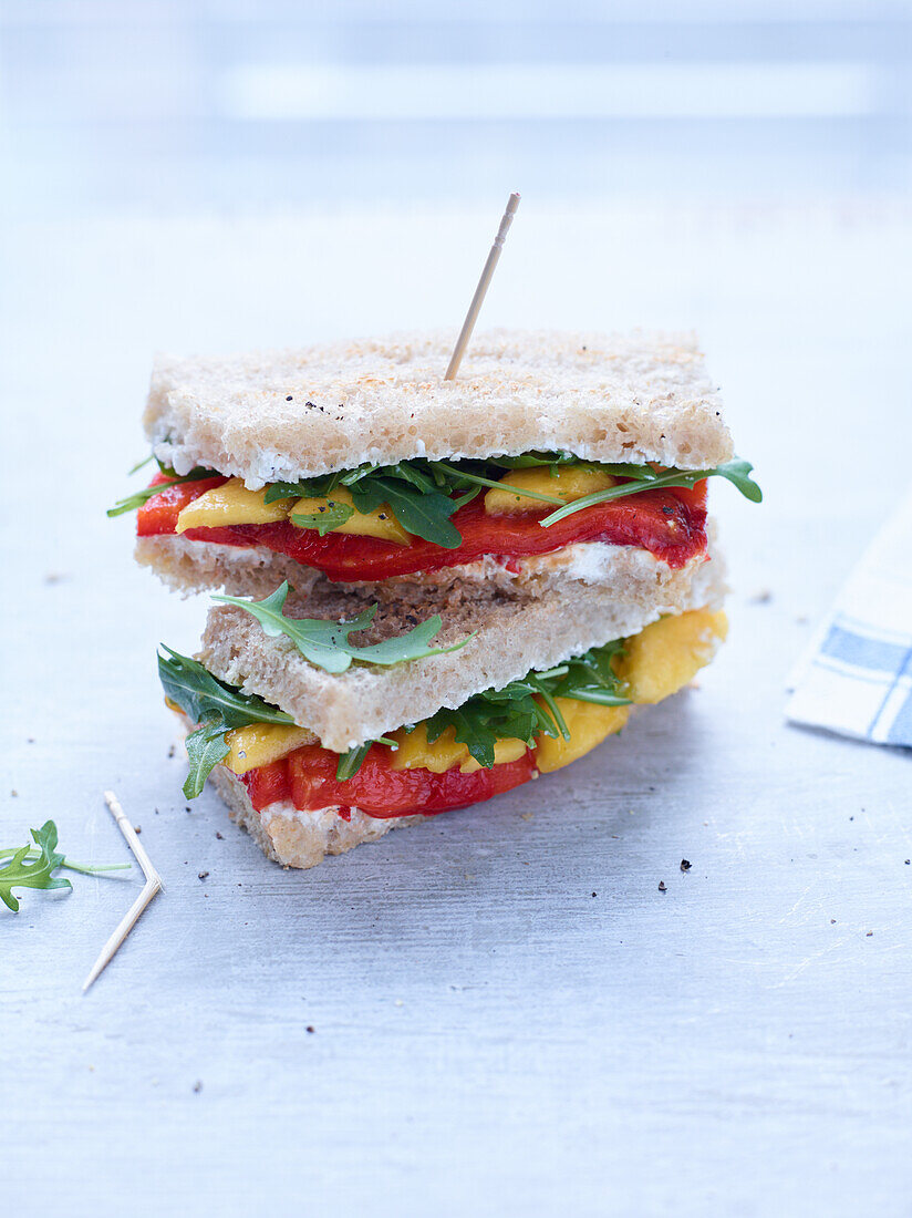 Veggie club sandwich with peppers and rocket salad