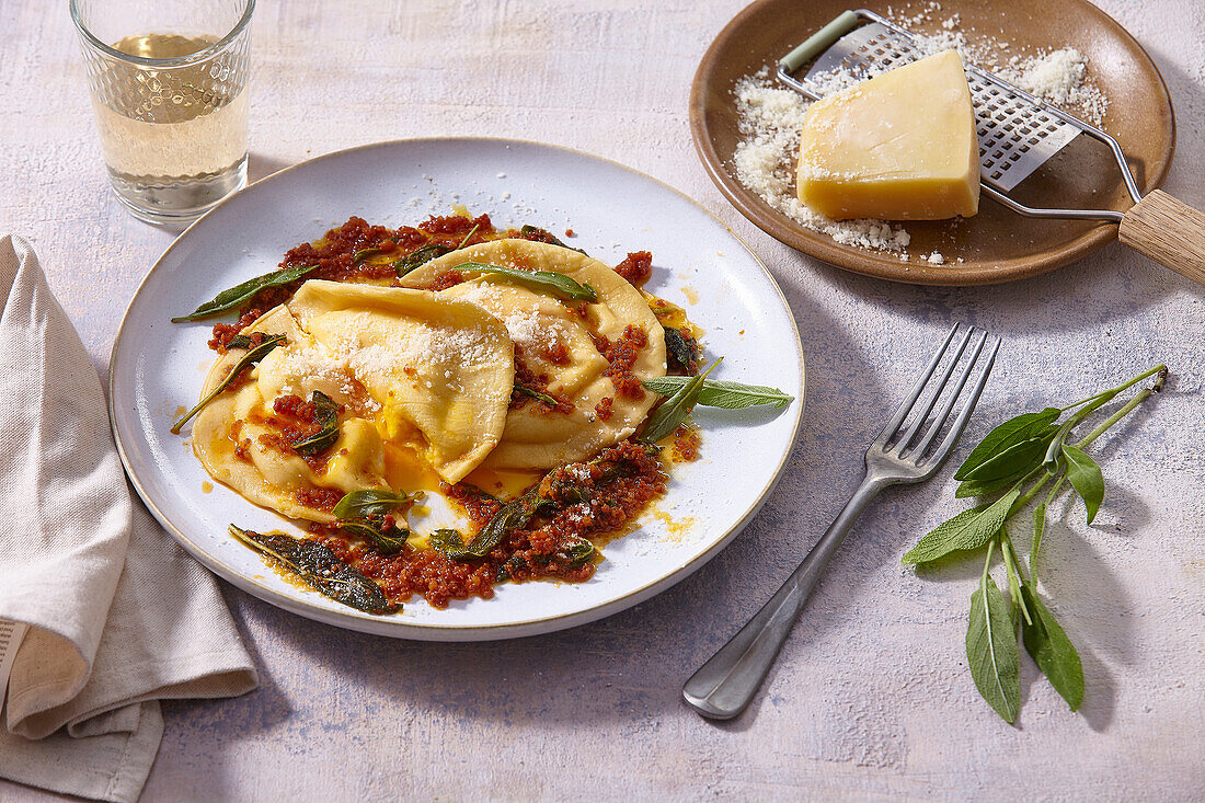 Ravioli with egg yolk filling, minced sausage and sage