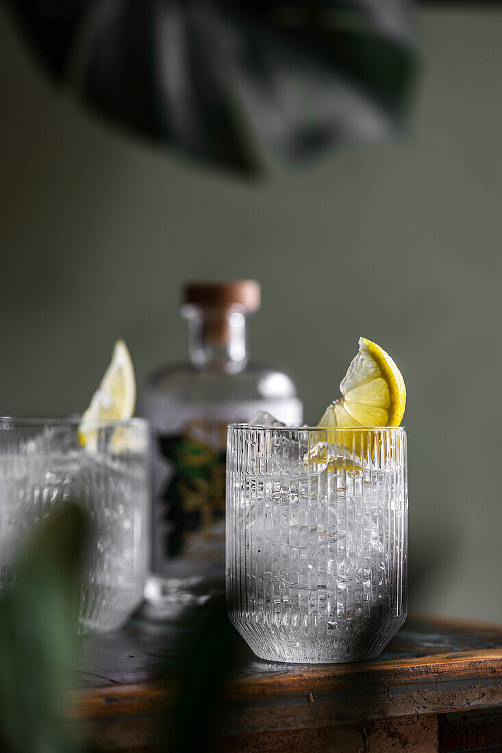 Clear cocktails with ice and lemon