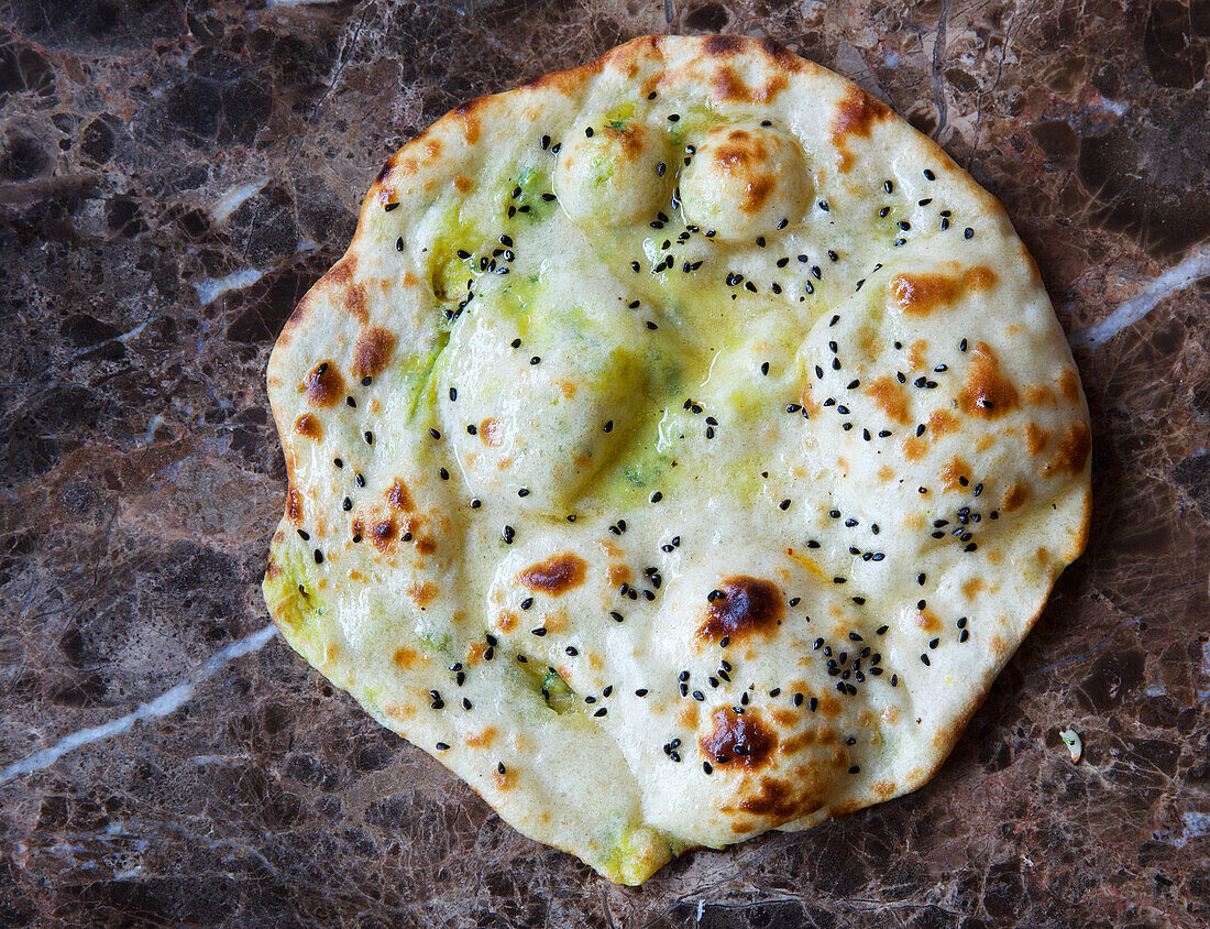 Paratha with butter, herbs and seeds