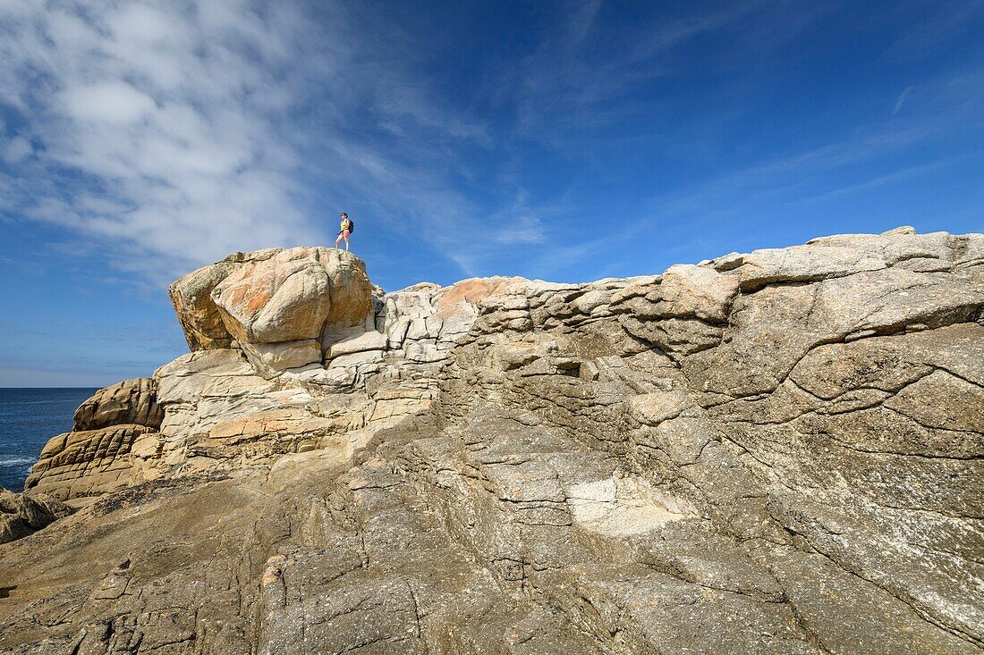 France,Finistere,Penmarch,hiker on the rocks of Saint-Guenolé