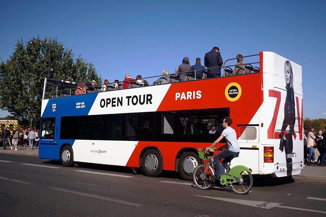 France,Paris,area listed as World Heritage by UNESCO,Double decker tourist bus on the banks of the Seine
