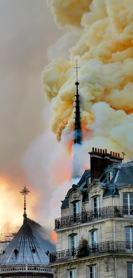 [ Unpublished - Exclusive ] France,Paris,area listed as World Heritage by UNESCO,Notre Dame Cathedral of 14th century Gothic architecture during the fire of 15th April 2019,the arrow flares up 20 minutes after the beginning of the fire,thick yellow smoke from the burning of the lead roof