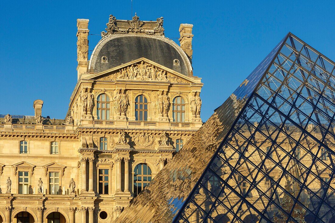 France,Paris,area listed as World Heritage by UNESCO,reflection of the facade of the Richelieu Wing on the pyramid of the Louvre by the architect Ieoh Ming Pei in the Cour Napoleon