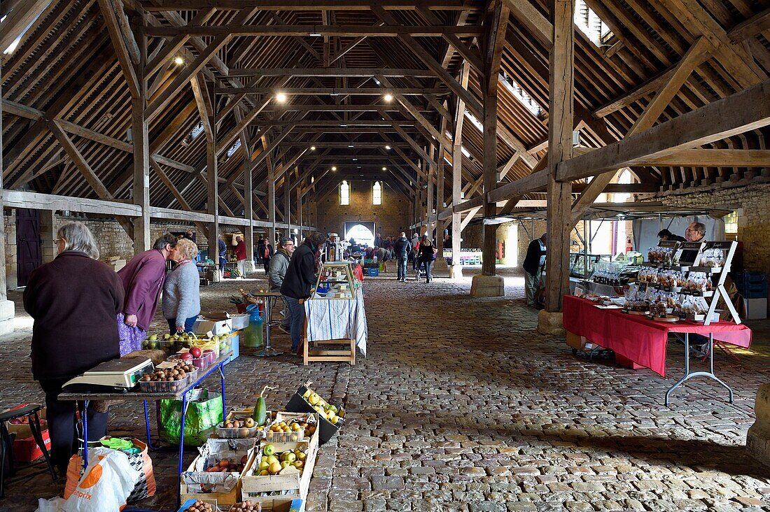 France,Calvados,Pays d'Auge,Saint Pierre sur Dives,sale of fruits and vegetables under the 11th century covered market rebuilt in the 15th century