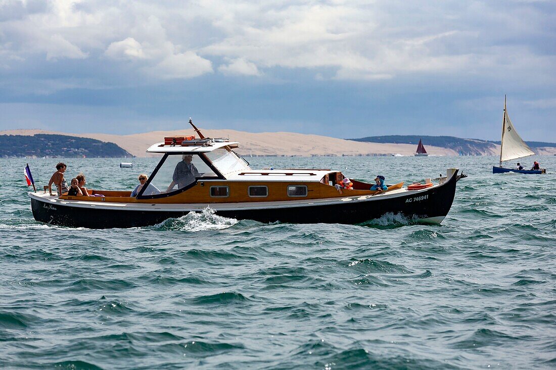 France,Gironde,Bassin d'Arcachon,La Teste de Buch,pinasse with the Dune of Pilat in the background