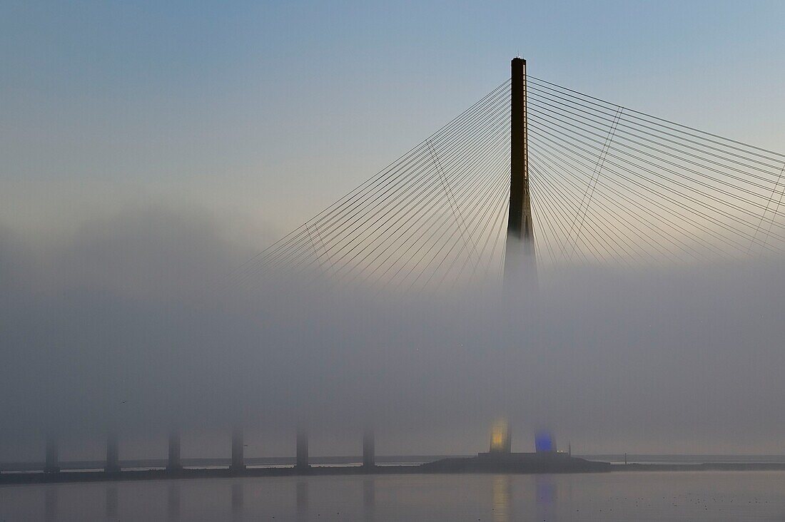 France,between Calvados and Seine Maritime,the Pont de Normandie (Normandy Bridge) in the mists of dawn,it spans the Seine to connect the towns of Honfleur and Le Havre