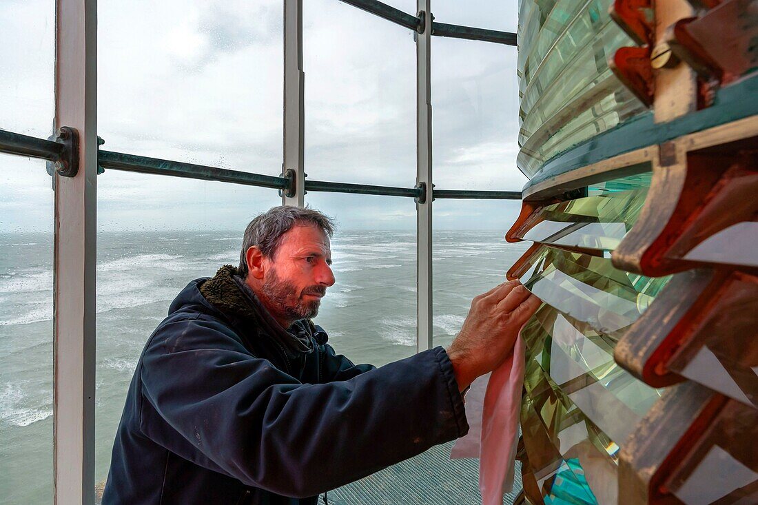 France,Gironde,Verdon sur Mer,rocky plateau of Cordouan,lighthouse of Cordouan,listed as Monument Historique,lighthouse keeper cleaning the Fresnel lens from the lantern