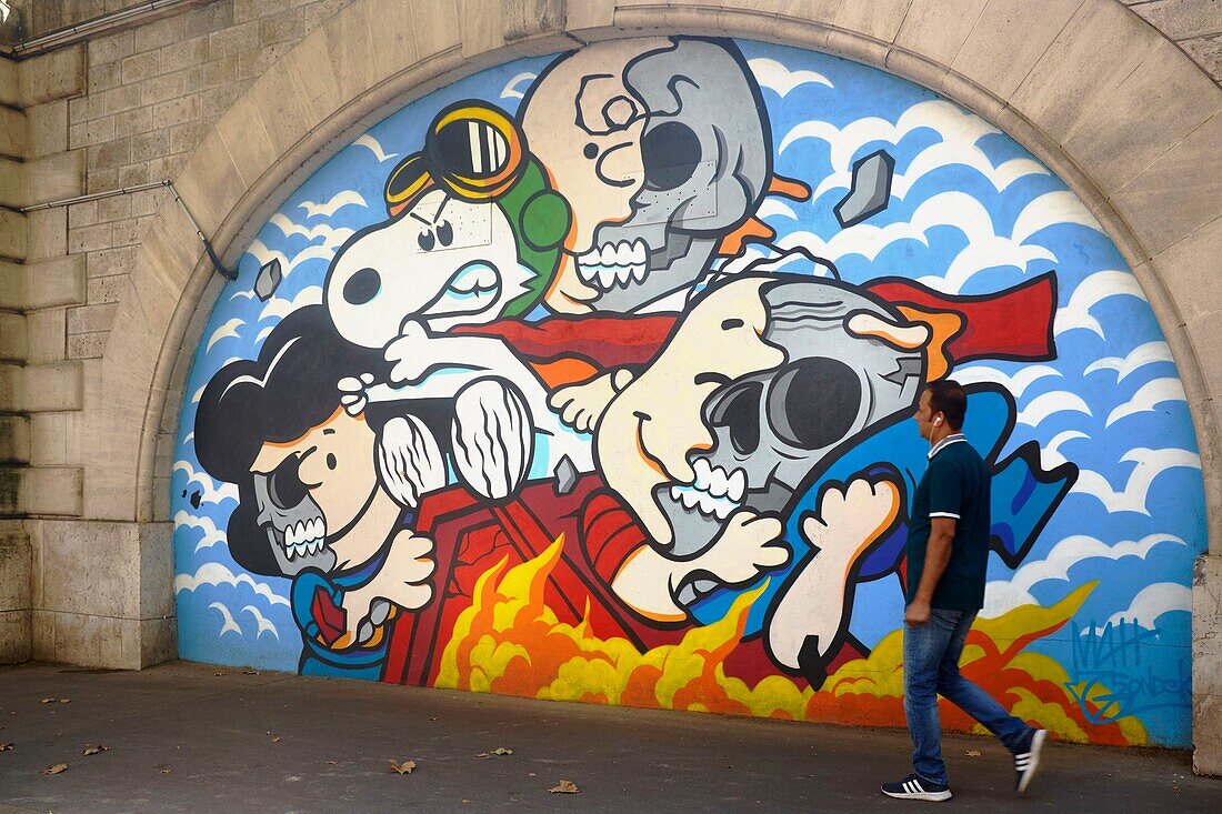 France,Paris,Street Art 13,bd Vincent Auriol,Pedestrian in front of a fresco by MAH under the aerial train