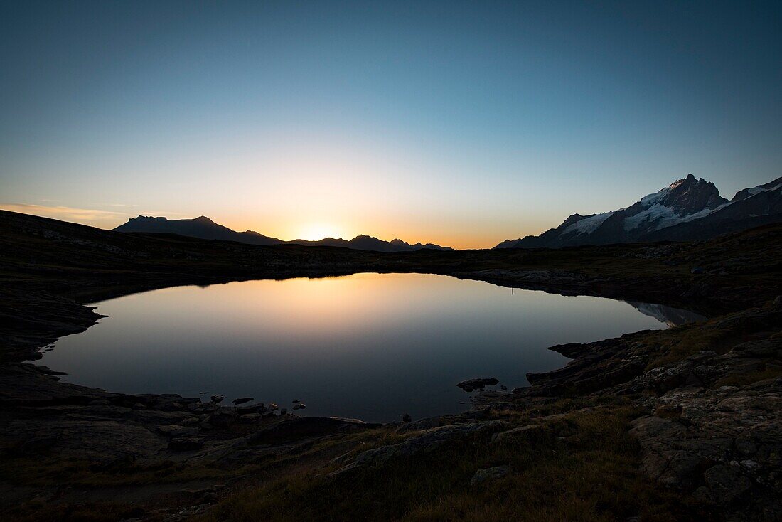 France,Hautes Alpes,la Grave,on the plateau of Emparis the Black Lake facing the massif of Meije at dusk