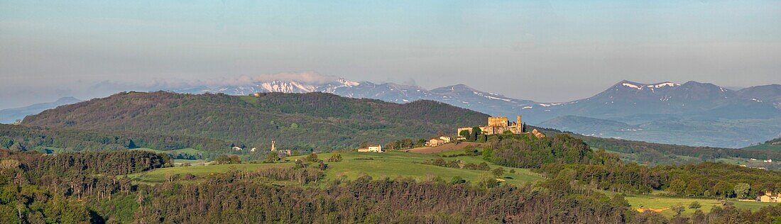 France,Puy de Dome,Montmorin castle in the Natural Regional Park of Livradois Forez and in the background the Regional Natural Park of the Volcanoes of Auvergne,Monts Dore,Sancy