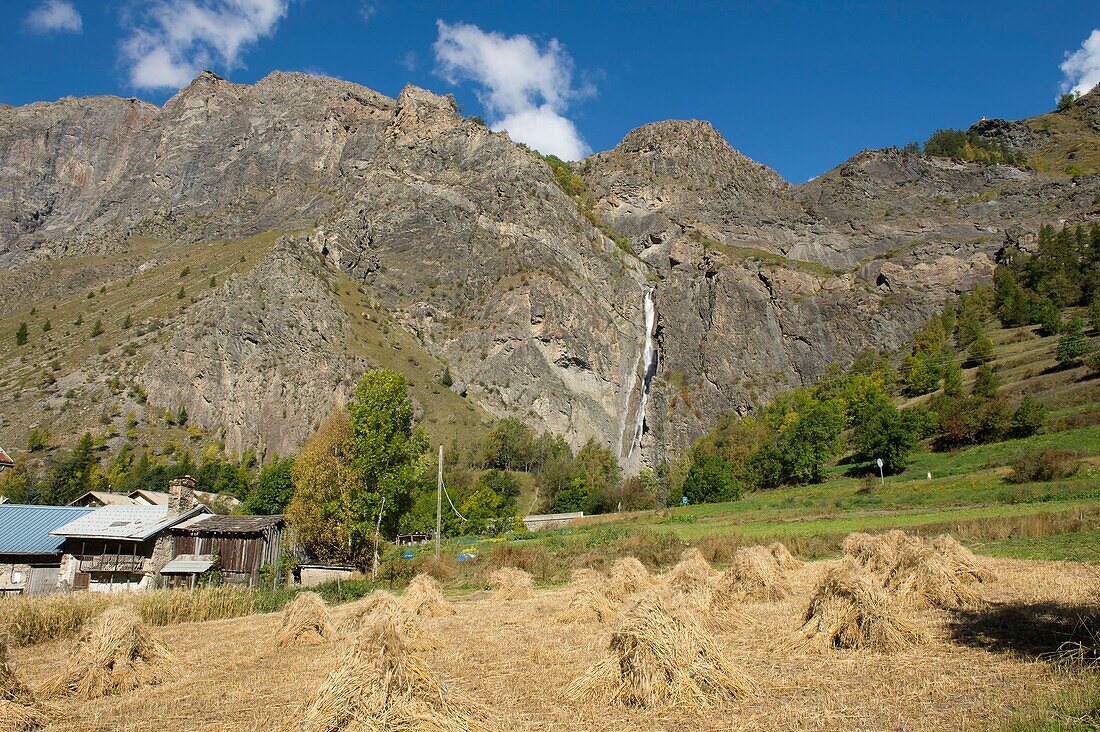 France,Hautes Alpes,The massive Grave of Oisans,the javelles of the harvest of rye in the old hamlet of Fréaux and the waterfall of the Pucelle