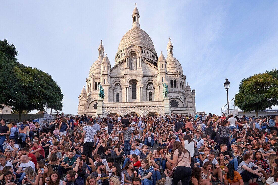 France,Paris,Montmartre,Crowd gathered under the Sacre Coeur Basilica during the Harvest Festival