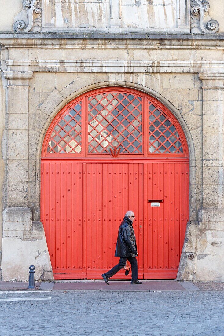 France,Meurthe et Moselle,Nancy,door,facade and man walking in the old town in Arsenal square