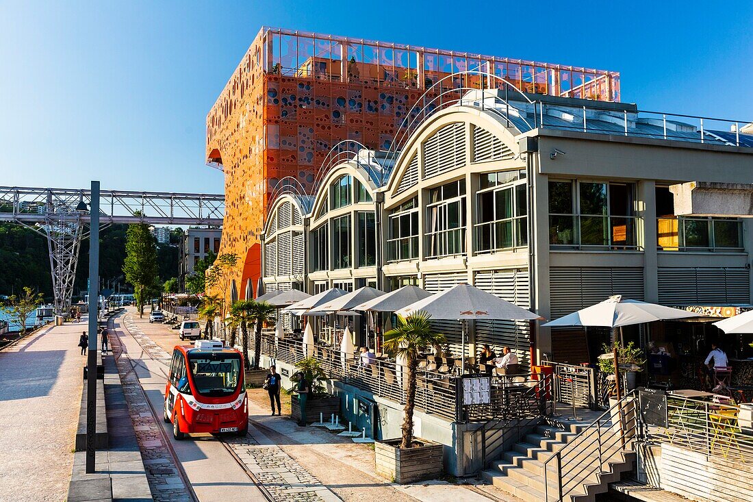 France,Rhone,Lyon,La Confluence district south of the Presqu'ile,close to the confluence of the Rhone and the Saone rivers,quai Rambaud along the former docks,Selcius restaurant and Pavillon des Salins also called Cube Orange and Navly,autonomous minibus without driver