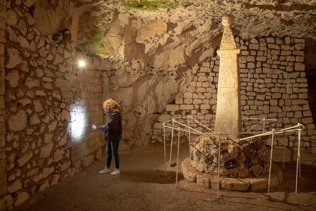 France,Somme,Naours,congress hall,woman illuminating the inscriptions of soldiers