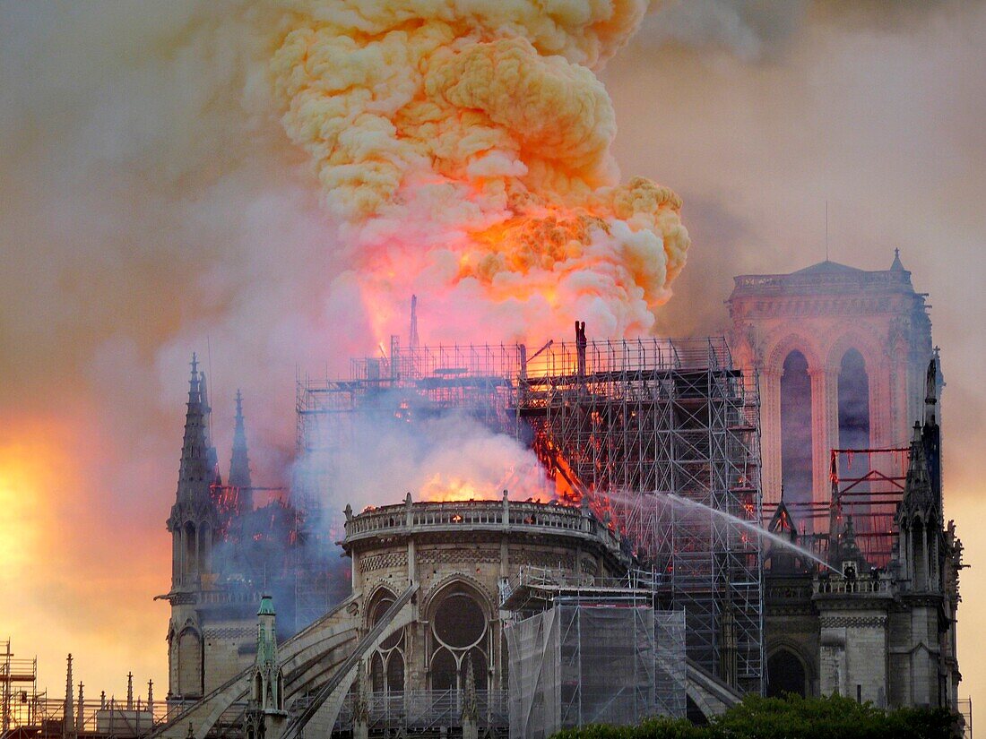 [ Unpublished - Exclusive ] France,Paris,area listed as World Heritage by UNESCO,Notre Dame Cathedral of 14th century Gothic architecture during the fire of 15th April 2019,collapse of the spire,scaffolding works of renovation and north tower in the background