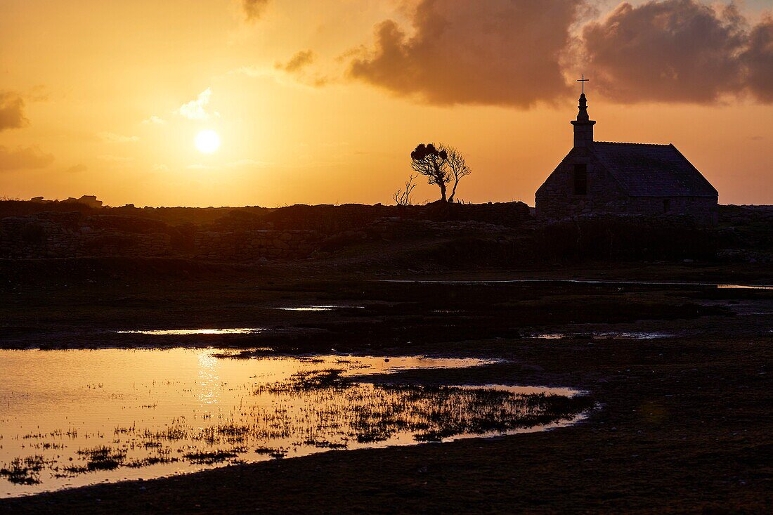 France,Finistere,Iroise Sea,Iles du Ponant,Parc Naturel Regional d'Armorique (Armorica Regional Natural Park),Ile de Sein,labelled Les Plus Beaux de France (The Most Beautiful Village of France),the Saint Corentin Chapel at sunset