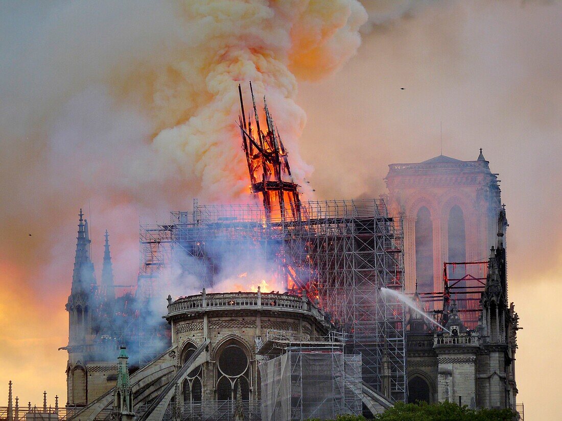 [ Unpublished - Exclusive ] France,Paris,area listed as World Heritage by UNESCO,Notre Dame Cathedral of 14th century Gothic architecture during the fire of 15th April 2019,overview of the broken spire before its imminent fall,scaffolding renovation work in the foreground,North tower in the background