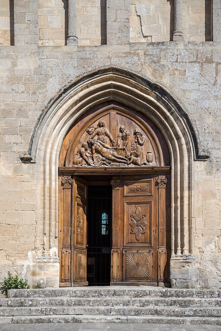 France,Vaucluse,regional natural reserve of Luberon,Saignon,the door of Notre-Dame de Pitié Church or Sainte-Marie de Saignon from the 12th century