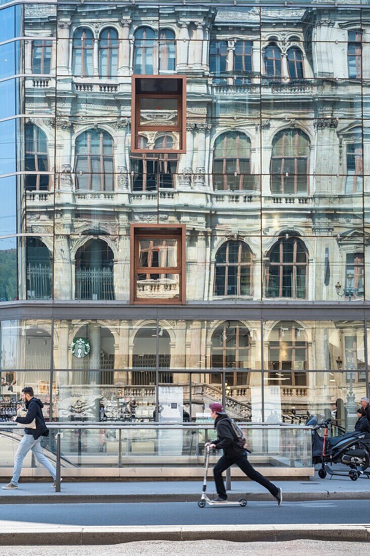 France,Rhone,Lyon,historic district listed as a UNESCO World Heritage site,Cordeliers square,reflection of the Palais de la Bourse de Lyon in the window of Monoprix