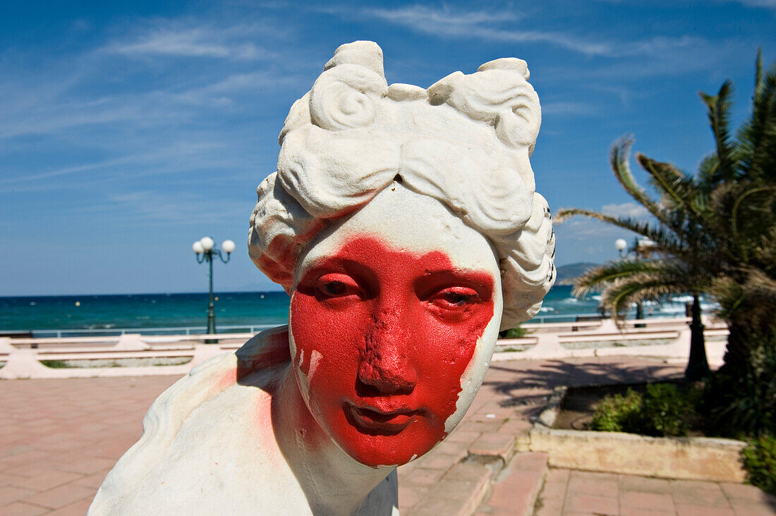 Grafittied statue on the seafront promenade at Ile Rousse. La Balagne. Corsica. France