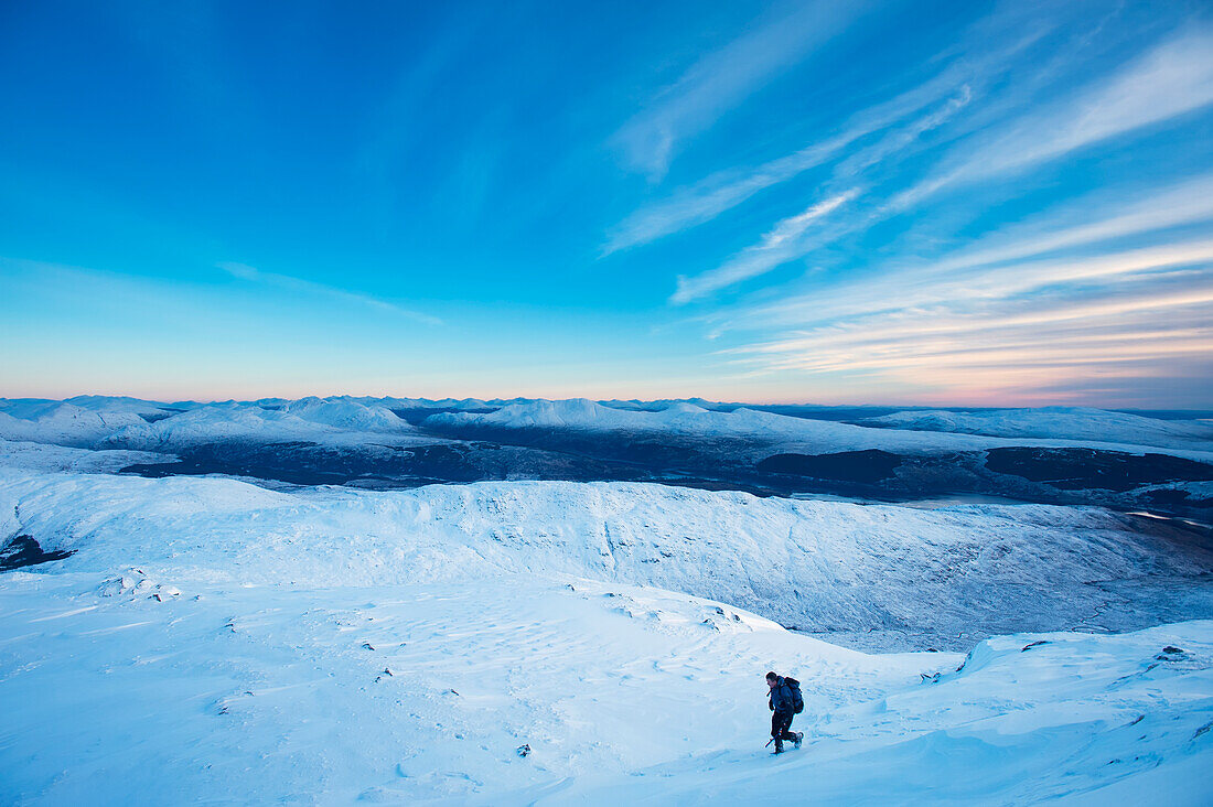 UK,Scotland,Man descending slopes of Beinn Respiol on Ardnamurchan peninsula,Highlands