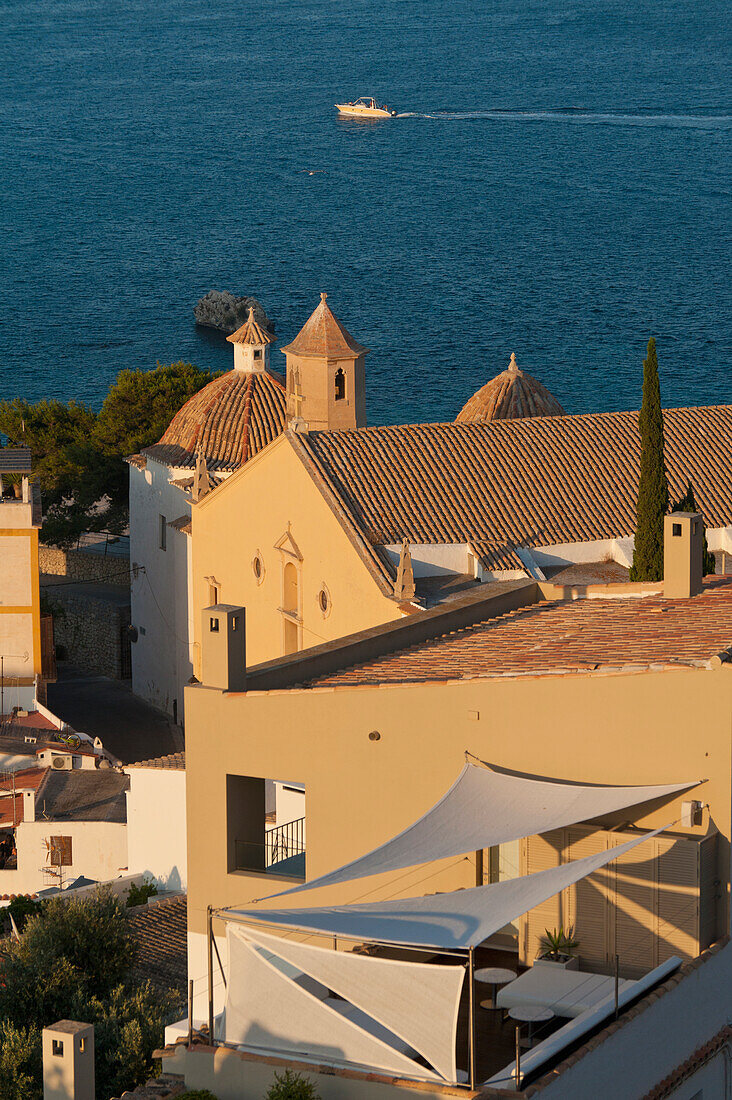 Spain,Ibiza,Looking over shaded roof terrace and Santo Domingo church in Dalt Vila,Ibiza Town