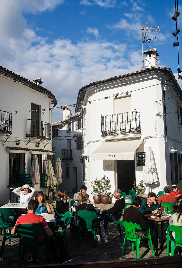 Tourists eating and drinking in the town of Grazalema,the hub of the Sierra de Grazalema Natural Park,a Unesco Biosphere reserve since 1977. Andalucia,Spain