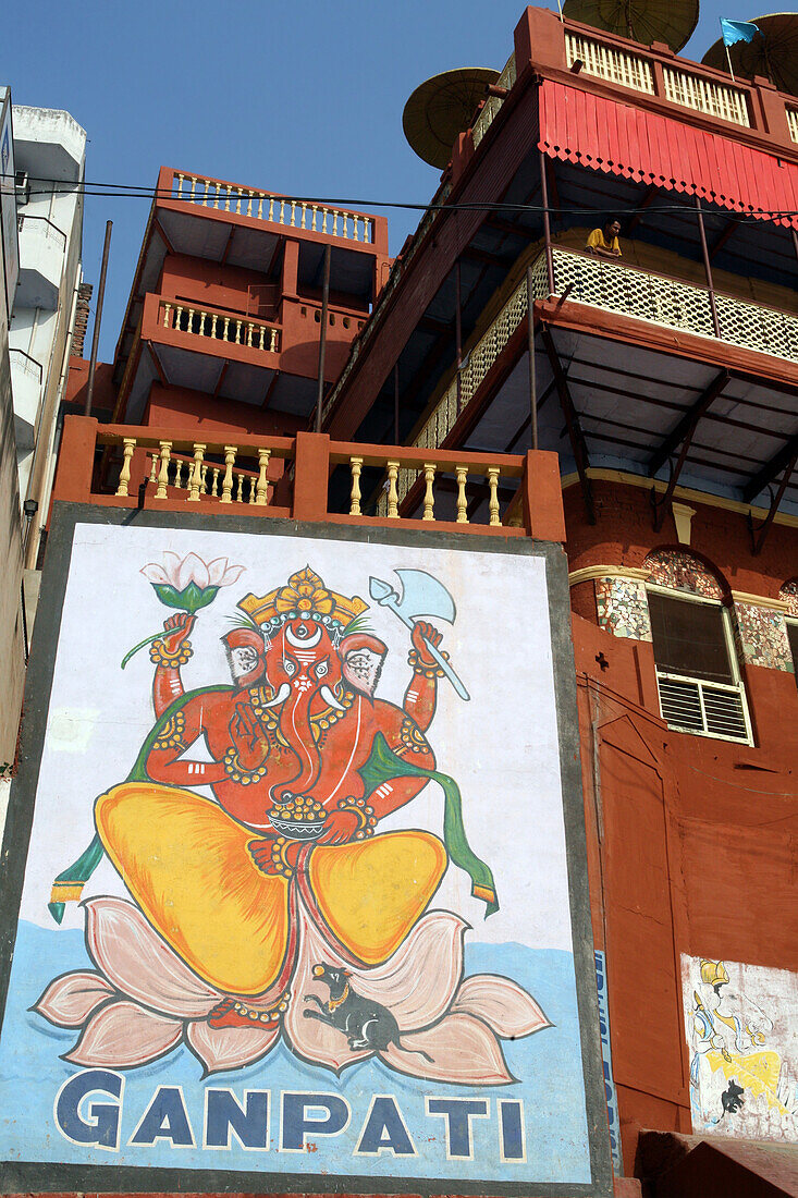 Entrance and wall mural to Ganpati Guest House cheap / budget accommodation with rooftop restaurant overlooking bathing ghats along River Ganges. The culture of Varanasi is closely associated with the River Ganges and the river's religious importance.It i