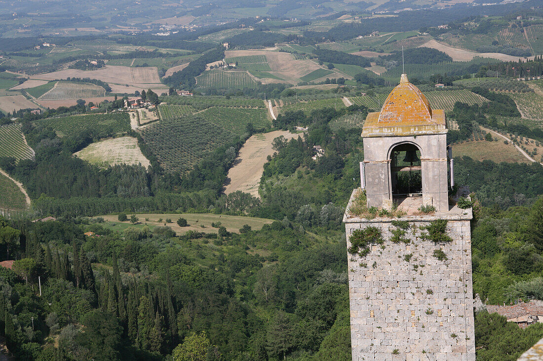 Old Bell Tower In Centre Of San Gimignano,A Famous Medieval Hilltop Town,Famed For Its Old Towers,And Surrounding Vineyards And Cypress Trees In Tuscany. Italy. June.