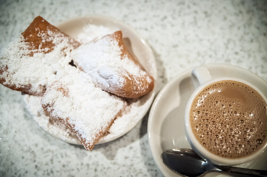 USA,Louisiana,French Quarter,New Orleans,Pastry with icing sugar and cup of coffee