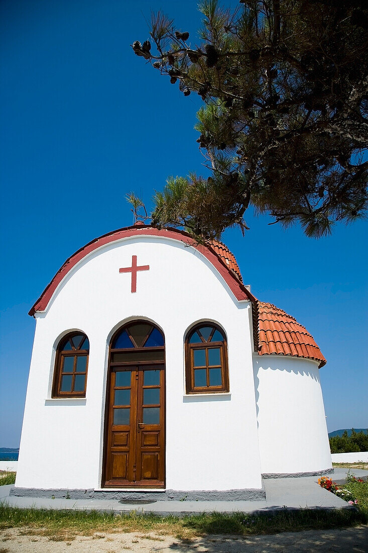 Greece,Halkidiki,Whitewashed Greek Orthodox church overlooking Mediterranean sea,Nea Roda