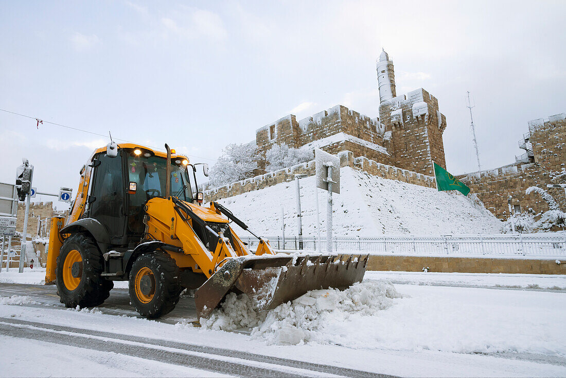 Israel,Old City walls and Tower of David in background,Jerusalem,Snow mower on street,2013,January 10