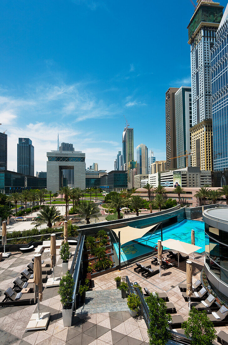 Blick über den Hotelpool zum Difc (Internationales Finanzzentrum Dubai), Dubai, Vereinigte Arabische Emirate