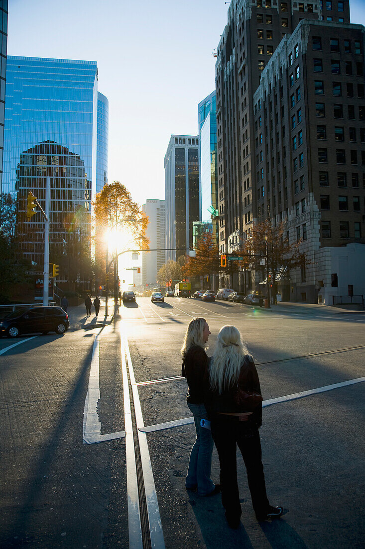 Two Women Standing In Street During Sunset,Downtown,Vancouver,British Columbia,Canada