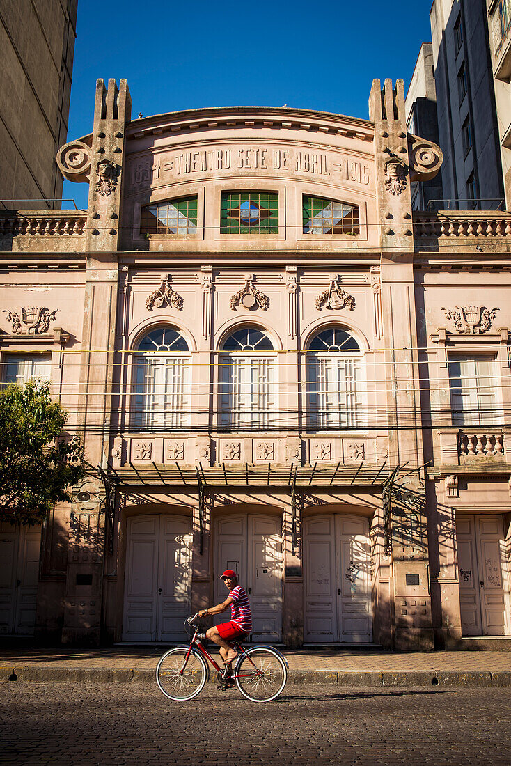 Brazil,Rio Grande Do Sul,Teenager On Bike In Front Of Theatro Sete De Abril In Residential District,Pelotas