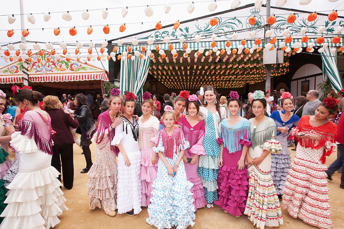 Gruppe junger Frauen in traditionellen Kleidern während des Feria-Festivals im April, Sevilla, Andalusien, Spanien